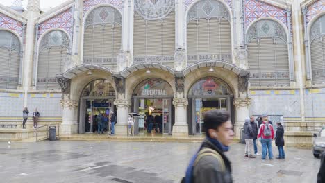 An-outside-view-of-a-beautiful-market-Mercat-Central-located-across-from-the-Llotja-de-la-Seda-and-the-church-of-the-Juanes-in-central-Valencia,-Spain