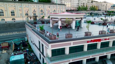 Aerial-view-of-a-girl-saluting-to-the-camera-in-Poshtova-square-in-Kiev