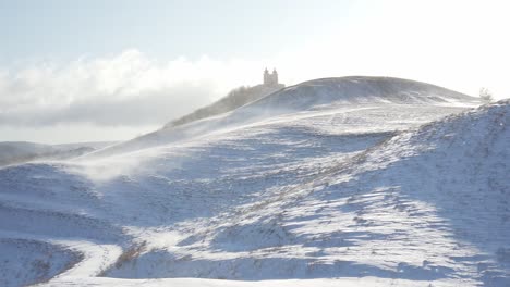 Wind-is-drifting-snow-in-hilly-mountain-area-and-forming-a-snow-storm