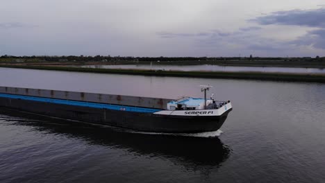 Bulk-Carrier-Traveling-With-Unloaded-Cargo-Holds-Against-Gloomy-Sky