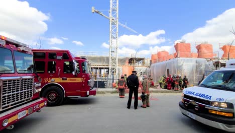 Police-and-Firefighters-working,-Firetruck-and-emergency-car-on-standby---slide-shot