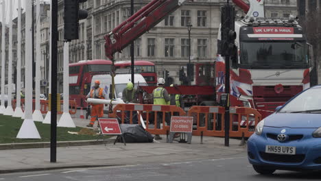 Workers-Clearing-Up-Rubbish-Beside-Knuckle-Boom-Crane-Lorry-At-Parliament-Square