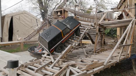 A-toy-truck-seen-crawling-on-a-custom-made-wooden-backyard-crawling-course