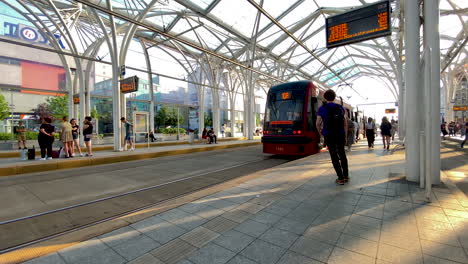 People-walking-on-historical-the-tramway-stop-in-Lodz,-Poland---Centrum-Tram-Station,-Piotrowska-Centrum-Stop,-designed-by-architect-Jan-Galecki