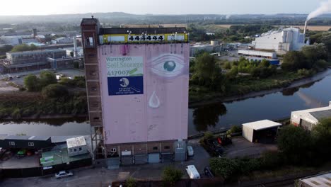 Icónico-Warrington-Ojo-Rosado-Fairclough-Mill-Self-Storage-Edificio-Vista-Aérea-Bajando-órbita-Izquierda