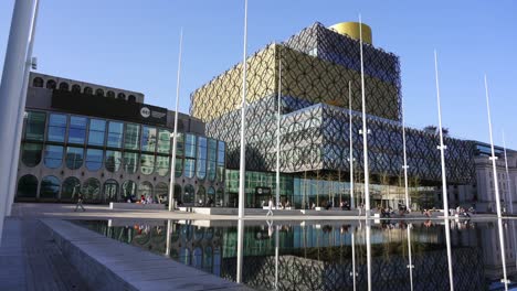 Slow-panning-show-of-Birmingham-city-center-showing-the-modern-architecture-of-the-library-and-Centenary-Sqaure-on-a-bright-sunny-day