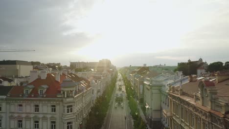 AERIAL:-Flying-Backwards-Over-Vilnius-Gediminas-Avenue-During-Warm-And-Sunny-Summer-Evening