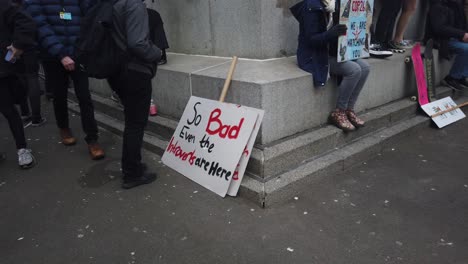 A-handmade-banner-leaning-on-a-statue-in-George-Square