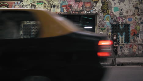 Suzuki-GN-motorcycle-parked-in-front-of-a-graffiti-building