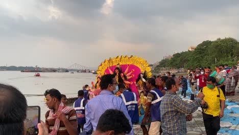 October-14,-2021--Kolkata,-West-Bengal,-India:-Submersion-of-Durga-idol-on-the-day-of-bijoya-dosomi-by-unidentified-group-people