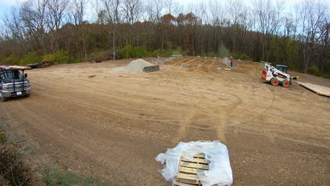 Time-lapse-of-two-men-preparing-and-bracing-the-principal-framing-poles-for-new-construction-of-a-pole-barn