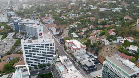 Vista-Aérea-Del-Tráfico-En-El-Bulevar-De-La-Puesta-Del-Sol,-Tarde-Soleada,-En-West-Hollywood---Pan,-Tiro-De-Drones