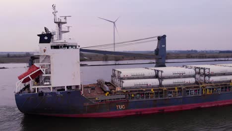 Aerial-Circle-Dolly-View-From-Starboard-Side-Of-Pacific-Fortune-Cargo-Ship-Along-Oude-Maas