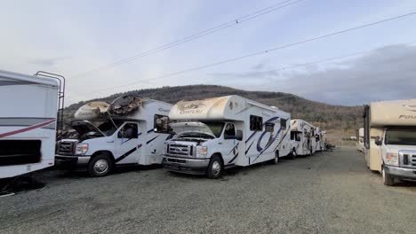 Broken-RV-camper-graveyard-after-fire,-damaged-recreational-vehicles,-four-winds-chateau