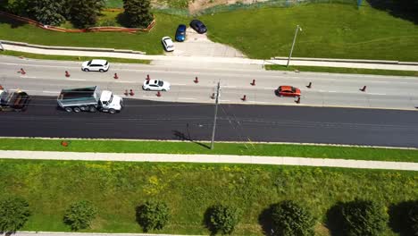 Aerial-view-of-heavy-equipment-re-surfacing-busy-roadway