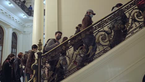 SANTIAGO,-CHILE---MAY-28,-2022:-Pan-to-the-right-of-a-group-of-people-climbing-the-internal-stairs-of-the-National-Library-of-Chile-on-Heritage-Day