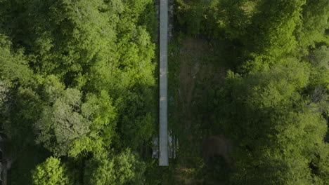 Fly-Over-Abandoned-Ski-Jumps-In-Lush-Forest-Mountains-Of-Bakuriani-In-Georgia