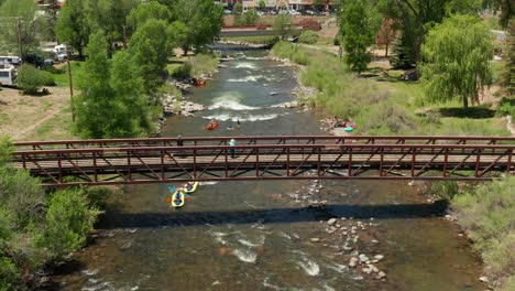 People-floating-down-the-San-Juan-River-in-inflatable-rafts,-Pagosa-Springs,-Colorado