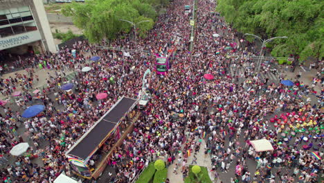 Drone-View-Over-Pride-Parade-Bus-And-Crowds-In-Mexico-Walking-Along-Paseo-De-La-Reforma-On-25-June-2022