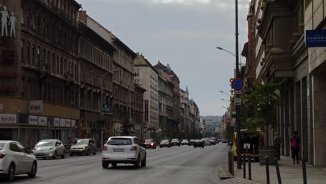 Budapest,-Hungary-September-02,-2022:-A-public-transport-bus-passes-in-front-of-the-camera-in-Rákoczi-Street,-downtown-of-Budapest