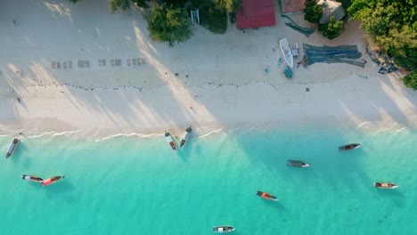 Nungwi-Beach,-Zanzibar---Tanzania---June-18,-2022---Boats-on-the-Indian-ocean-on-a-sunny-cloudy-day-during-sunrise