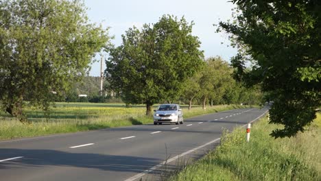 Two-Skoda-cars-driving-fast-on-a-country-road-at-sunset