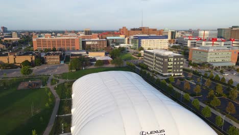 Ascending-aerial-close-up-shot-of-Wayne-County-Fairgrounds-on-a-sunny-day-with-a-green-park