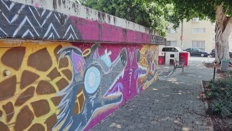 A-vibrant-energy-of-Tel-Aviv's-street-art-scene-featuring-colorful-graffiti-of-a-gray-wolf-and-a-yellow-giraffe-texture-against-a-solid-purple-background