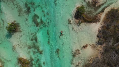 Person-Relaxing-In-Los-Rapidos-De-Bacalar-In-Mexico,-Aerial-Top-Down