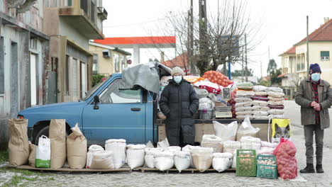 Couple-Is-Selling-Agricultural-Crops-And-Grains-With-Pick-Up-Truck-At-Background-In-Leiria,-Portugal