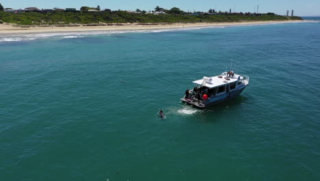 Orbiting-aerial-of-scuba-charter-boat-anchored-off-Santa-Casa-Beach