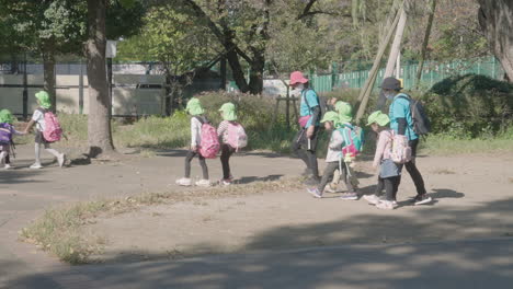 Teachers-Accompanying-A-Group-Of-Students-On-Educational-Trips-During-Sunny-Day-In-A-Park-At-Tokyo,-Japan