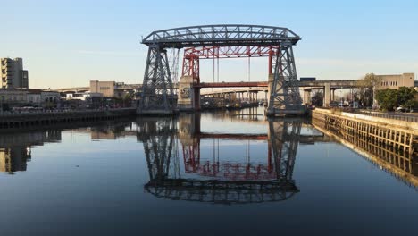 Low-aerial-push-in-of-famous-steel-bridges-over-river-in-Buenos-Aires