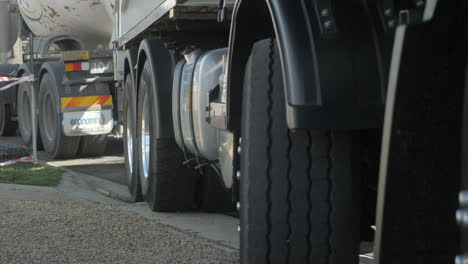 CLOSE-UP-Cement-Truck-Wheels-At-Construction-Site,-SLOW-MOTION