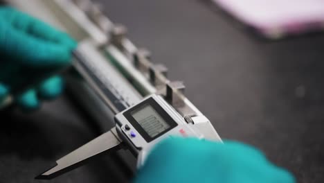 Middle-Aged-Engineer-in-Glasses-Working-with-High-Precision-Laser-Equipment,-Using-Lenses-and-Testing-Optics-for-Accuracy-Required-Electronics