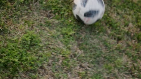 Person-is-rolling-and-kicking-soccer-ball-in-field