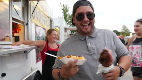 Guy-Shows-Off-His-Tasty-Turkey-Leg-At-A-4th-of-July-Picnic-at-a-Church-Stock-Video-Footage-#2