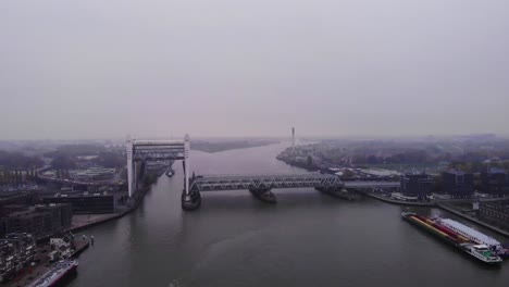 Aerial-View-Of-Raised-Spoorbrug-Railway-Bridge-Over-Oude-Maas-On-Cloudy-Day