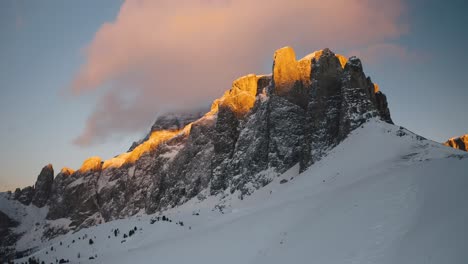 A-Drone-pan-snowy-ridge-toward-gold-light-on-Torri-del-Sella