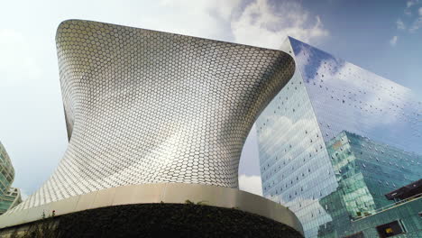 Outside-the-Soumaya-Museum,-landmark-modern-steel-building,-skyscraper-in-Mexico-City