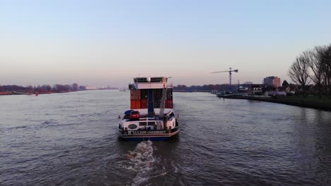 Aerial-Tracking-Shot-Behind-Juliam-Cargo-Ship-Along-Oude-Maas