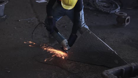 industrial-safety-first-concept,-casting-foundry,-Internal-grinding-of-a-cylindrical-part-with-an-abrasive-wheel-on-a-machine,-sparks-fly-in-different-directions