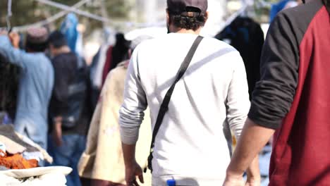 Old-Woman-And-Locals-Walking-Past-At-Saddar-Bazaar-On-Sunny-Day-In-Karachi