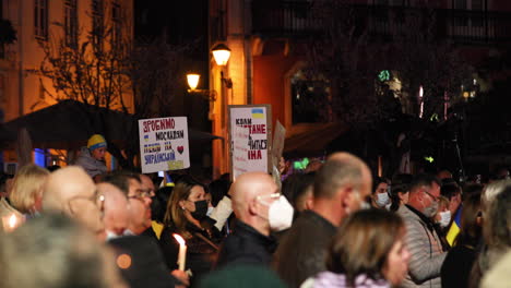 Portuguese-People-With-Placards-And-Ukrainian-Flags-Praying-For-Peace-In-Ukraine-At-Night-In-Leiria,-Portugal