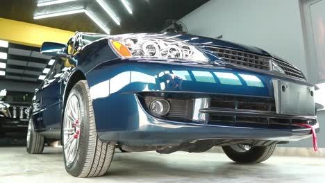 Low-Angle-View-Of-Left-Side-Of-Mitsubishi-Saloon-Car-In-Show-Room