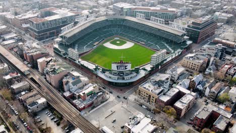 Aerial-view-away-from-the-Wrigley-Field,-Stadium-of-the-Chicago-Cubs---pull-back,-drone-shot