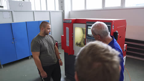 Group-Of-Students-Listen-To-Instructor-During-Demo-Of-A-Modern-Industrial-Machine-In-Vocational-High-School