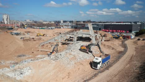 AERIAL:-Remnants-of-National-Stadium-in-Vilnius-with-Truck-Being-Filled-with-Debris