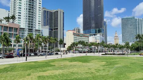 Urban-city-background-with-a-palm-trees-and-tall-buildings-with-a-huge-garden-|-An-Urban-city-with-a-clean-road-and-tall-building-cityscape-video-background-in-4K