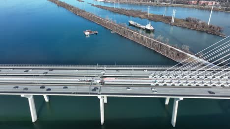 Transportation-heavy-traffic-on-Samuel-de-Champlain-bridge-linking-Quebec-to-Montreal,-Canada,-tracking-shot